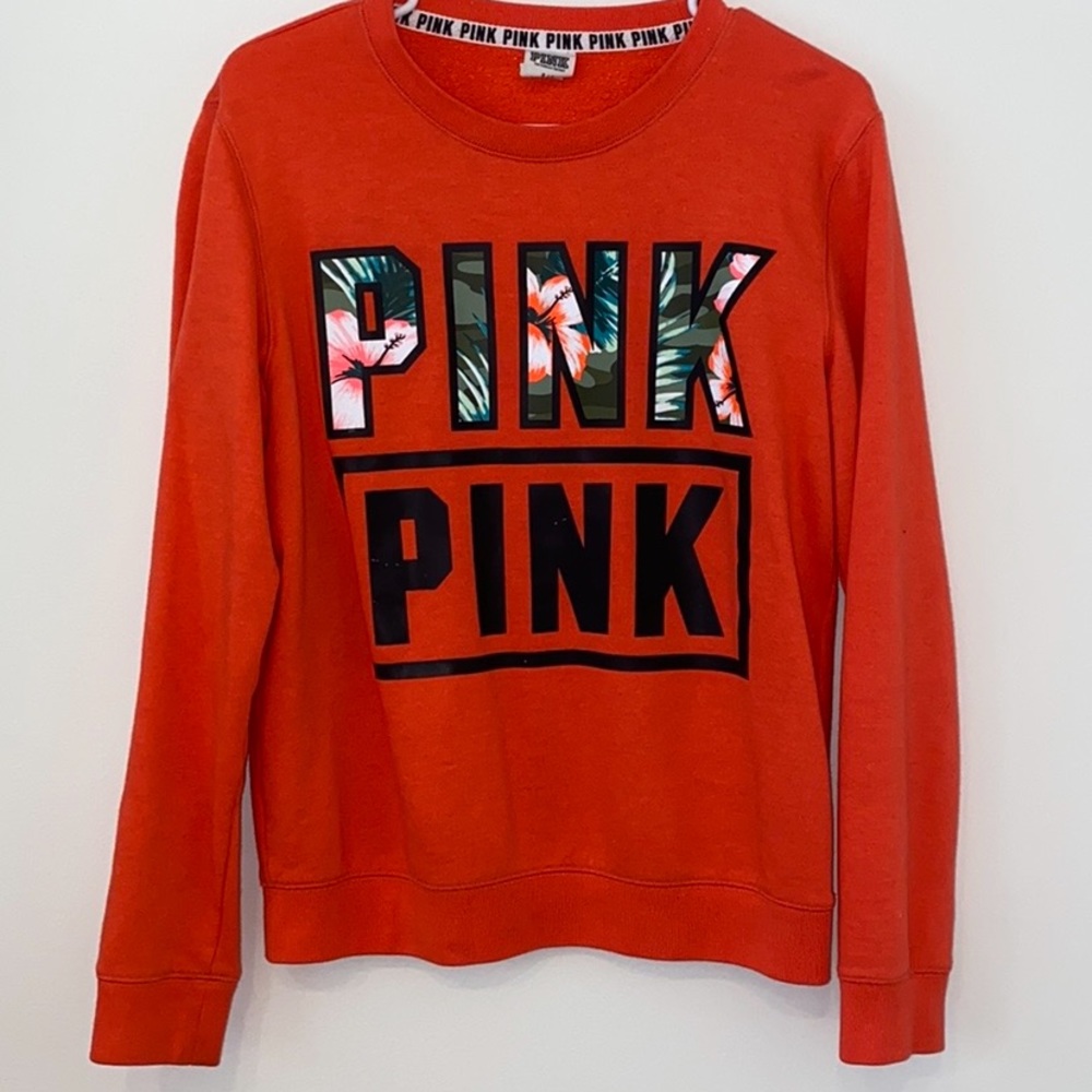 Orange sweatshirt.